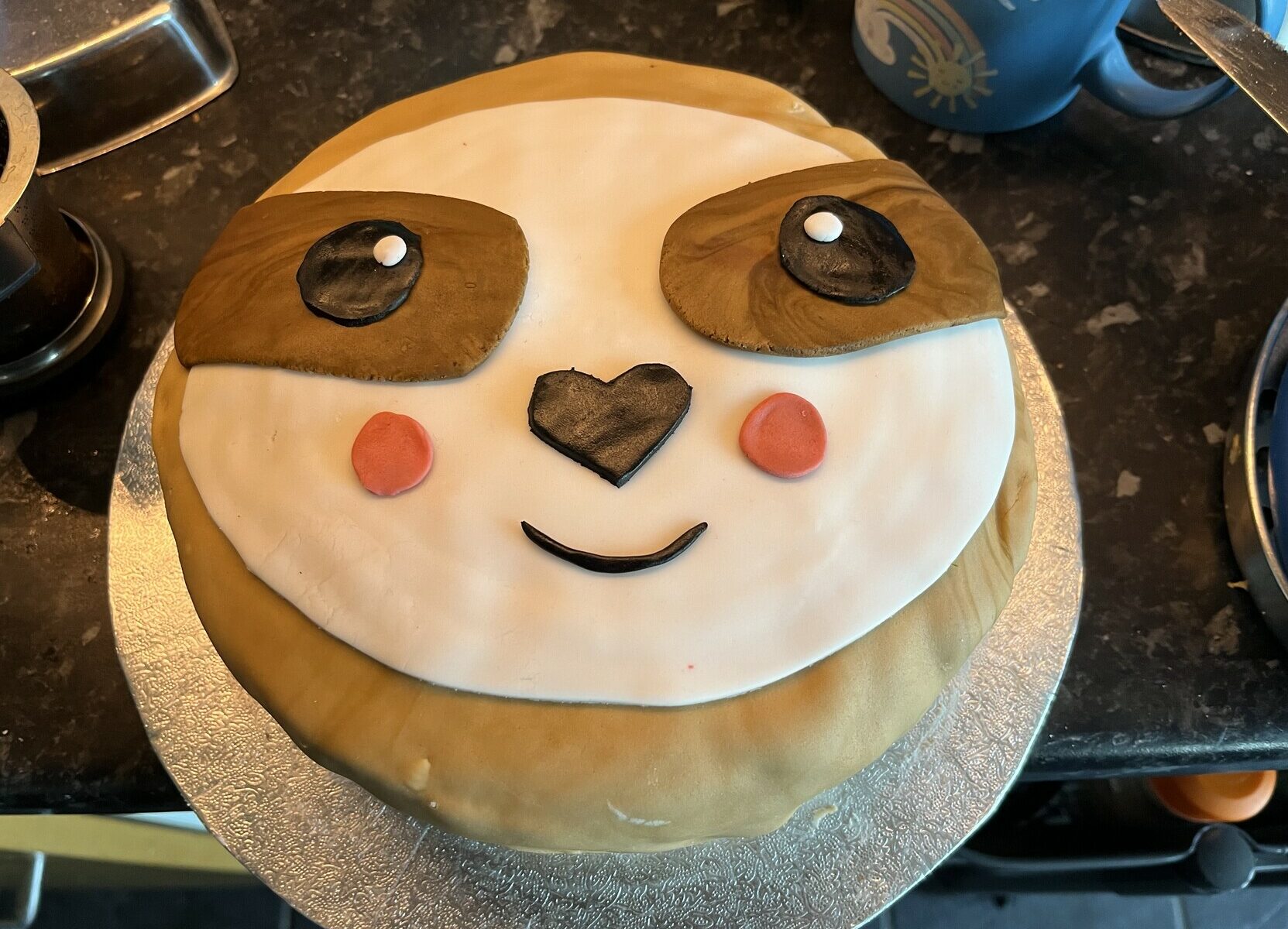 Photo of a cake decorated with a picture of a sloth - the animal type!