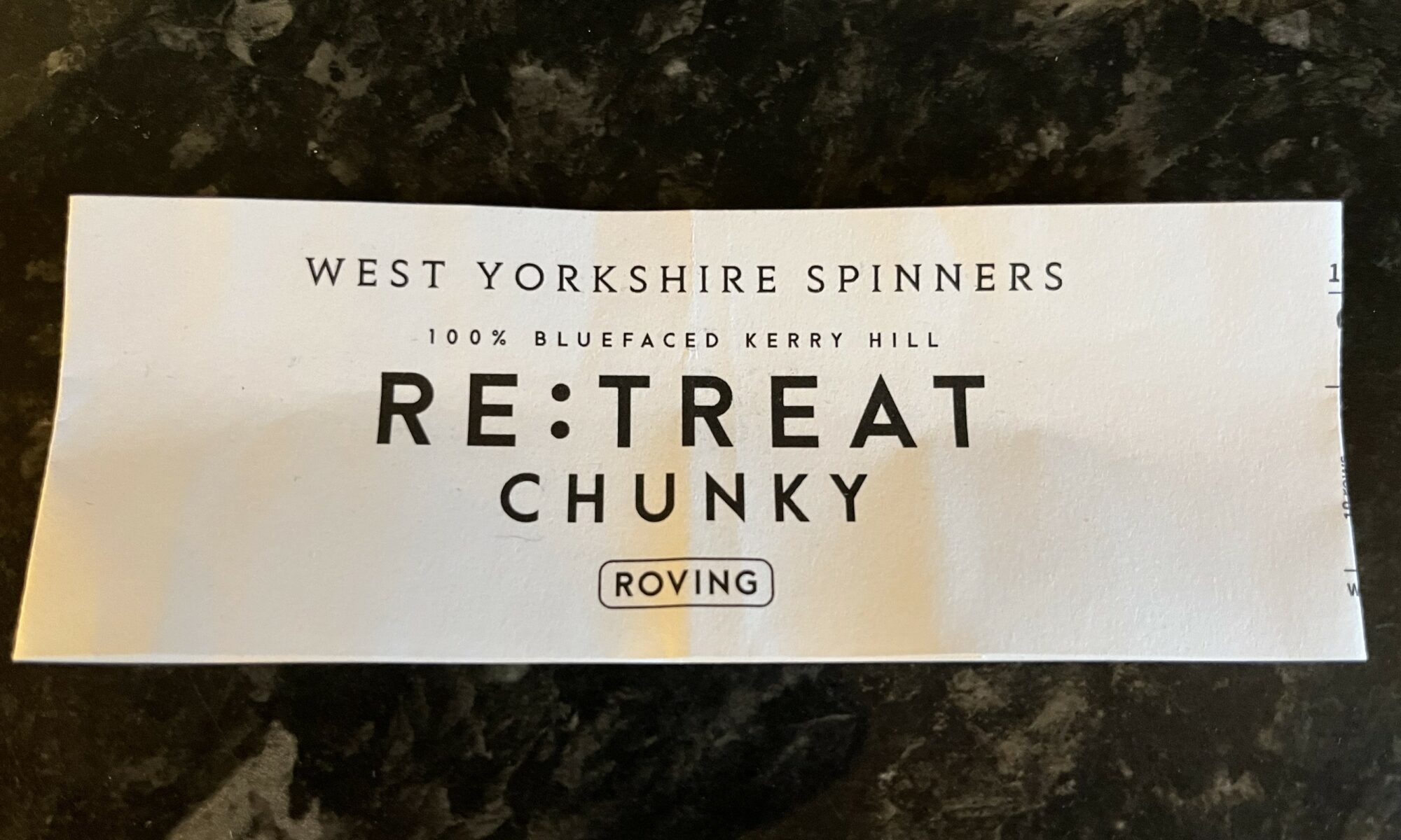 A label that reads (I kid you not): “West Yorkshire Spinners. 100% Bluefaced Kerry Hill. Re:treat. Chunky. Roving.”