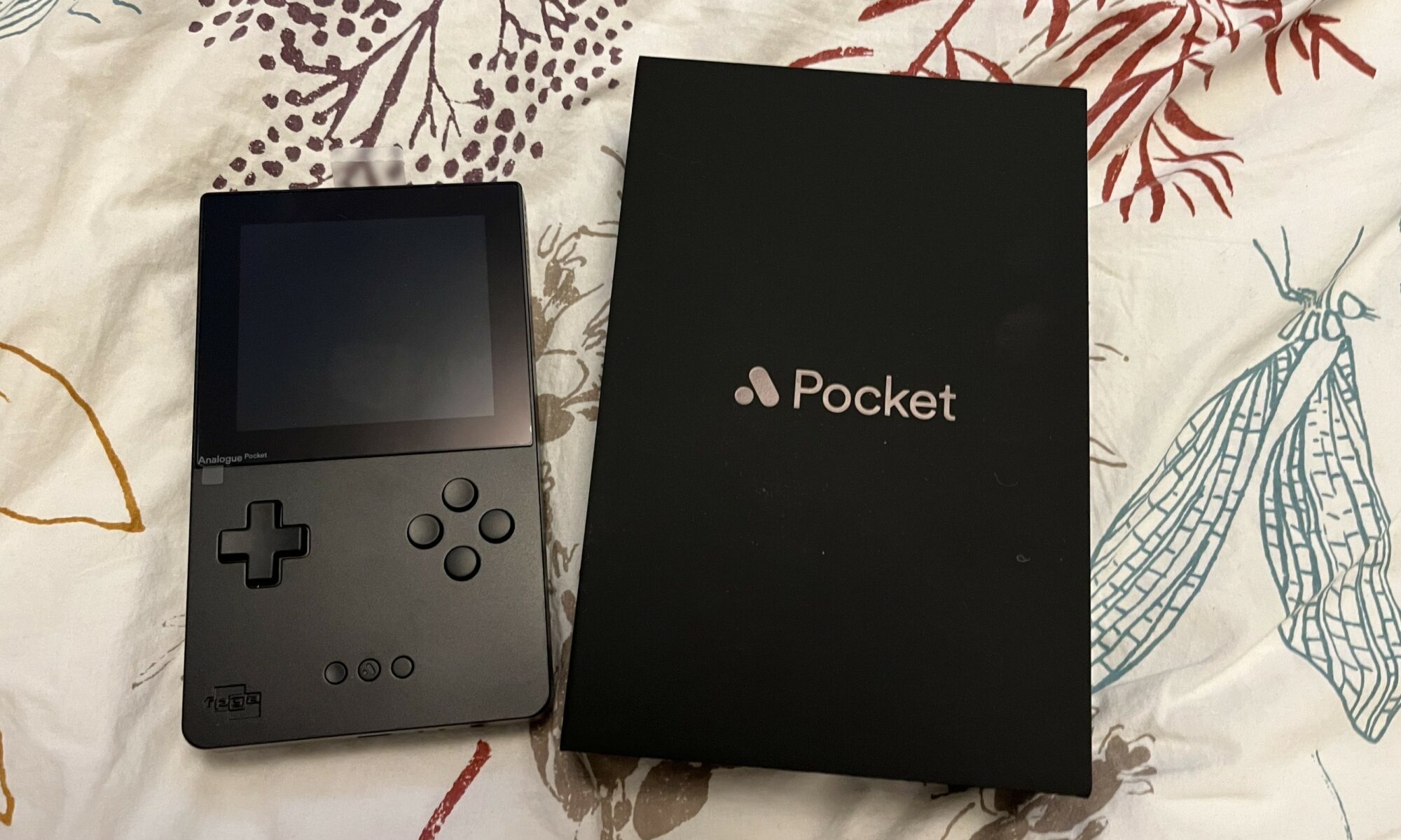 An Analogue Pocket retro gaming device with its box