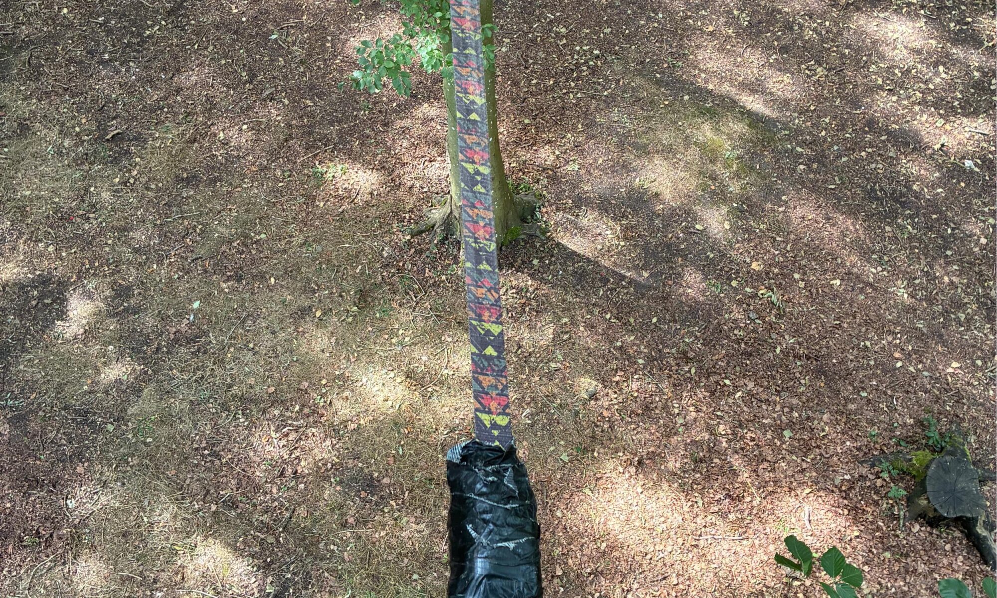 A slack line high up in trees, with a lot of gaffer tape wrapped around it
