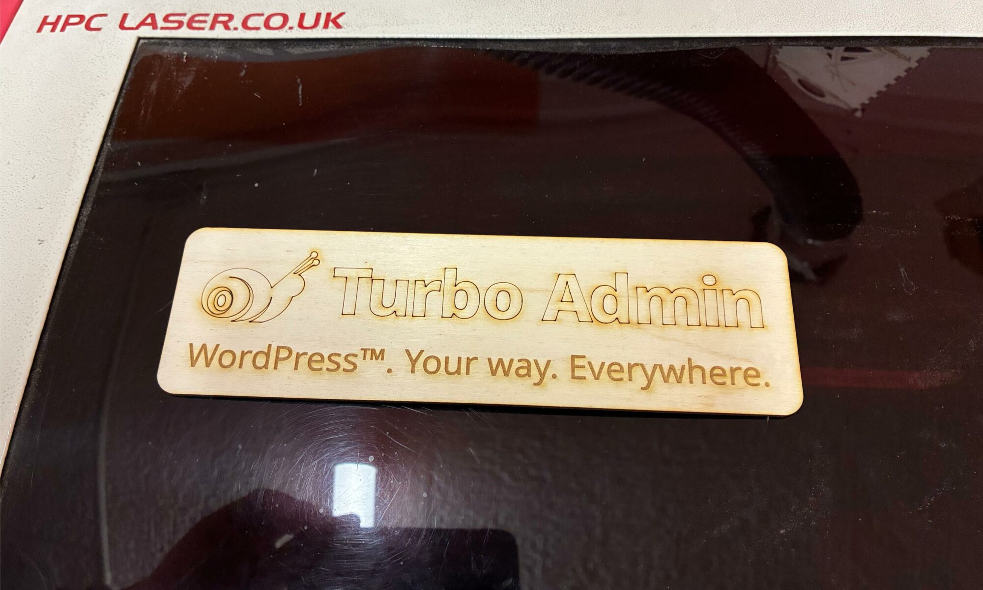 A piece of plywood with my Turbo Admin logo etched into it.
